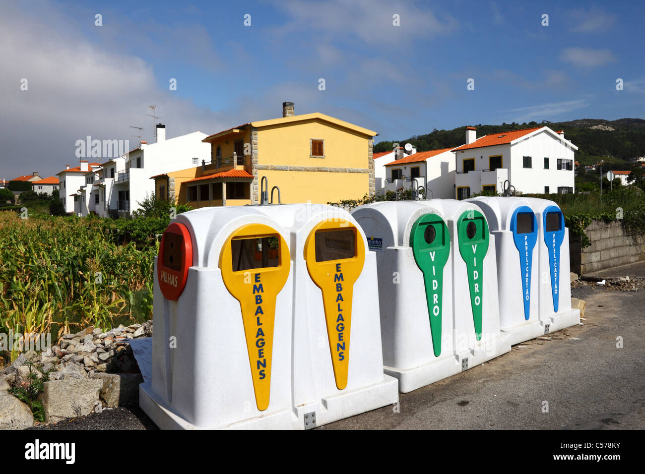 Recycling bins next to maize field and housing estate, Vila Praia de Ancora, northern Portugal Stock Photo