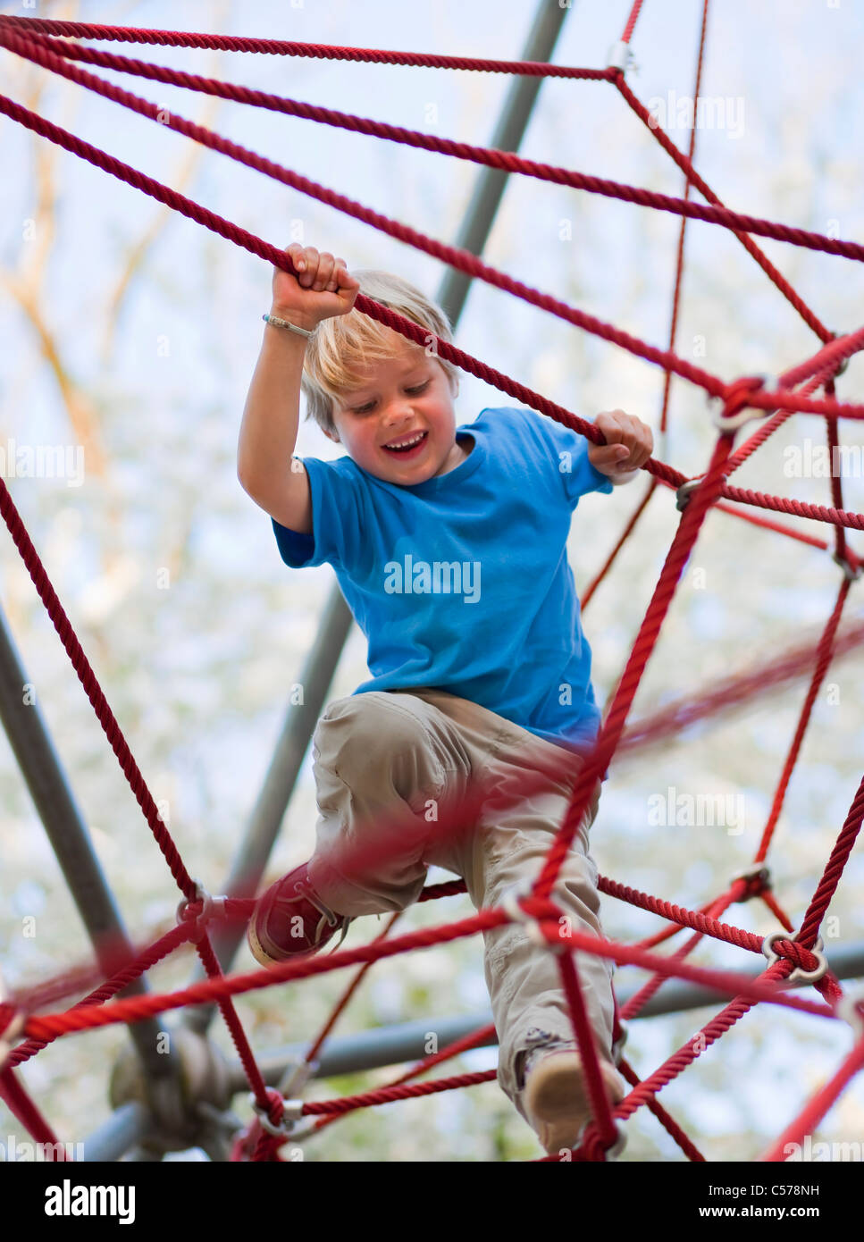 Boy climbing at playground Stock Photo Alamy