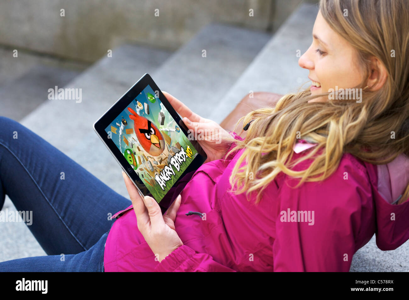 Close up view of woman's hand playing 'Angry Bird' game on an iPad 2 Stock Photo