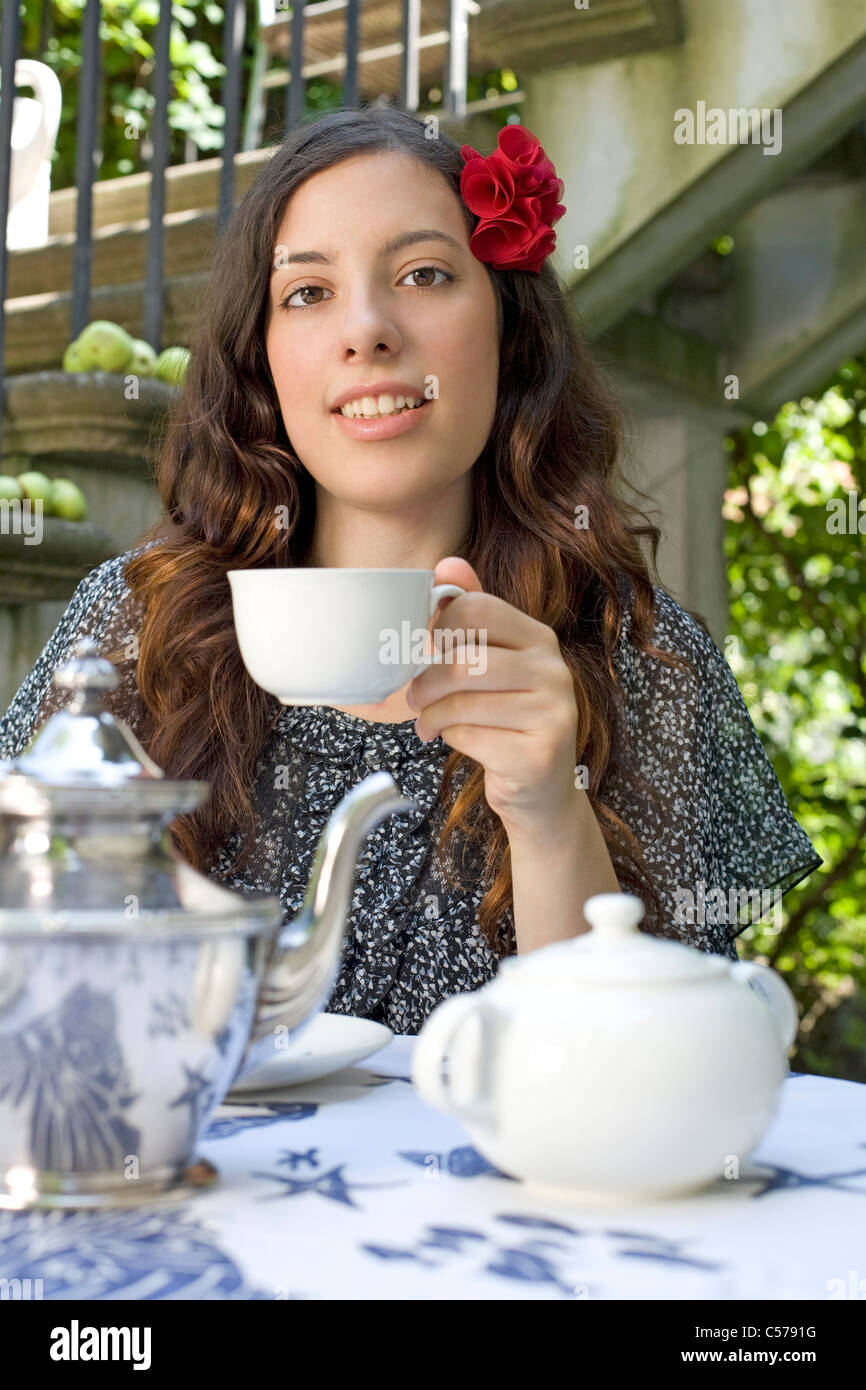 young woman drinking tea in garden Stock Photo Alamy