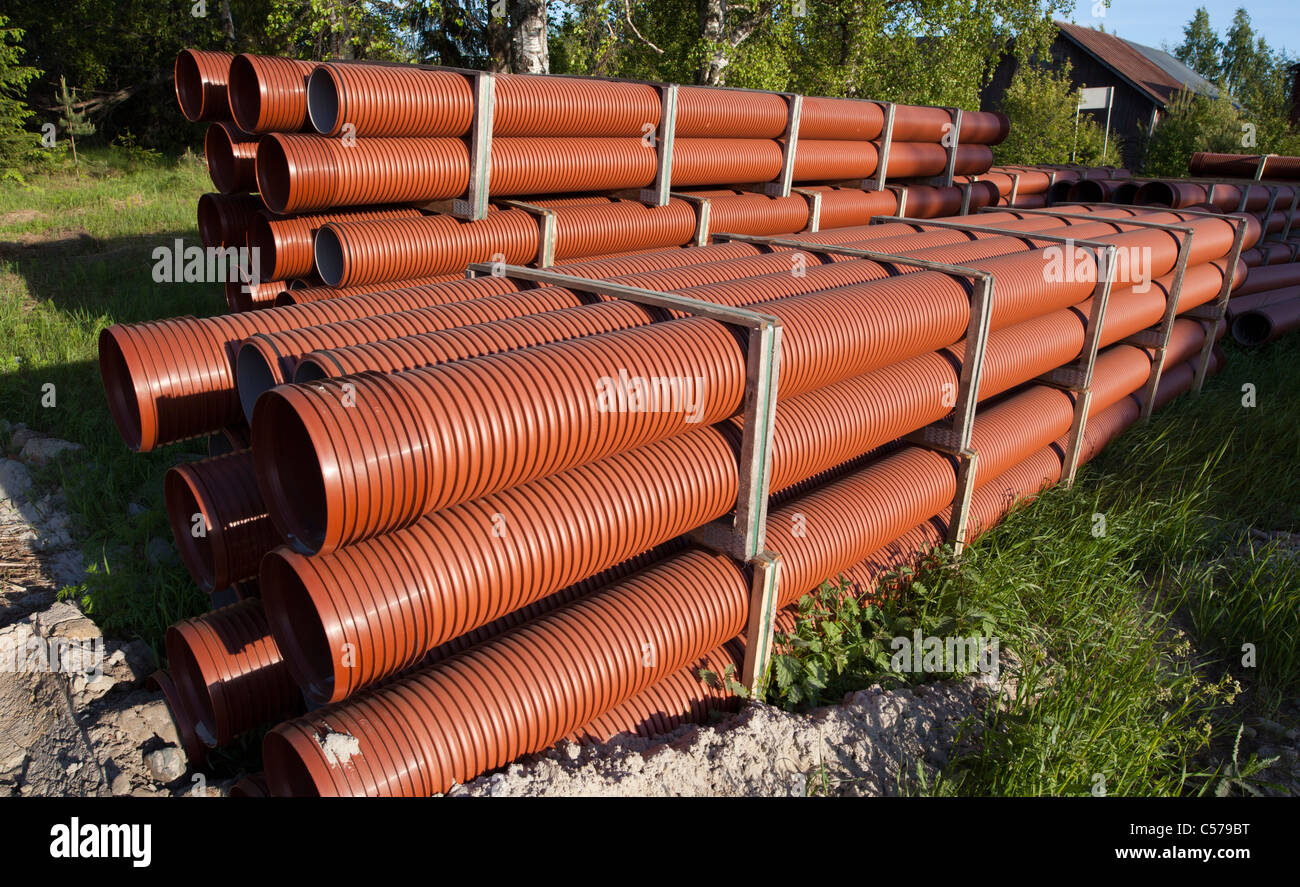 Pile of PVC drainage / sewer pipes waiting for assembly , Finland Stock Photo