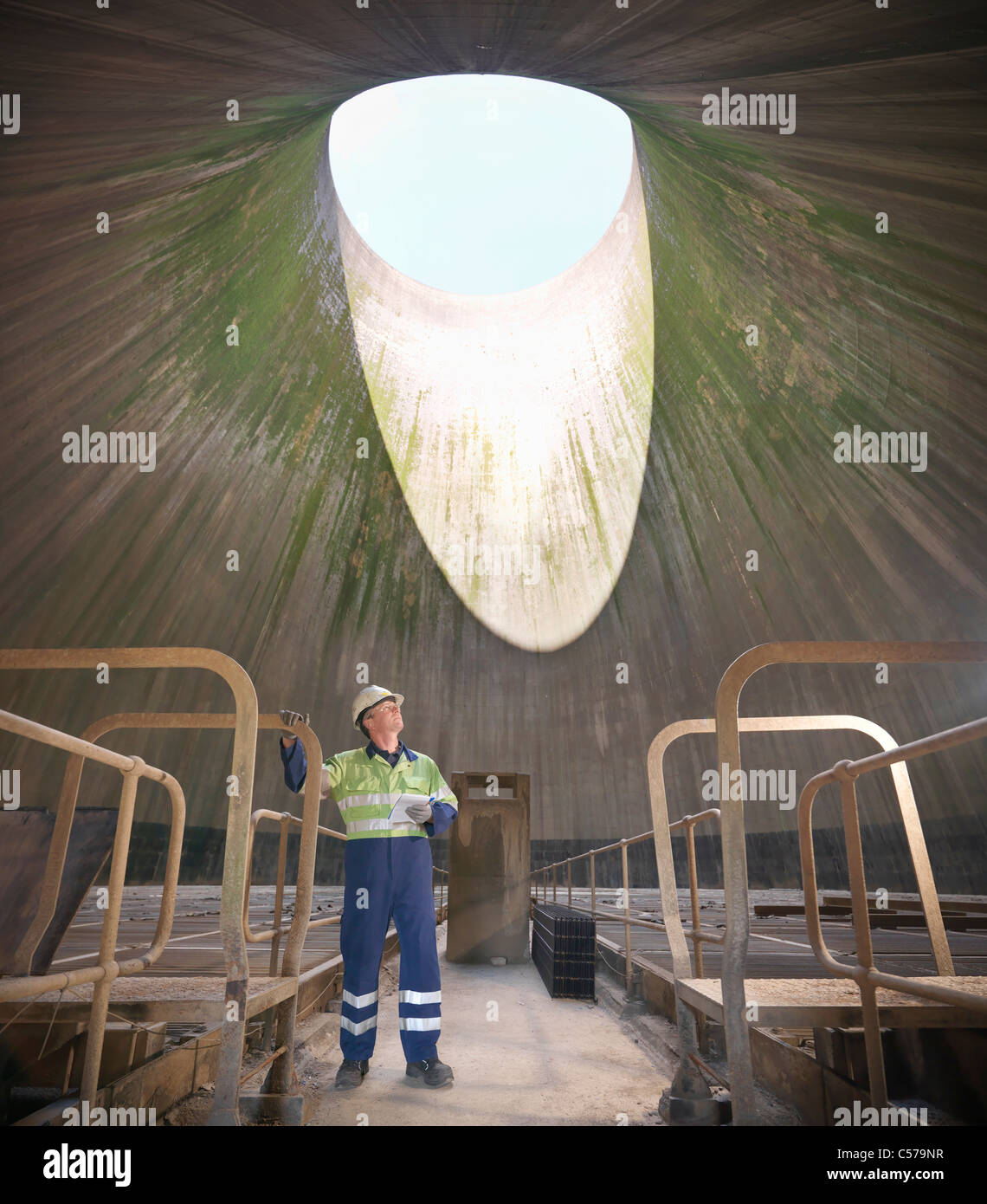 Worker in cooling tower of power station Stock Photo
