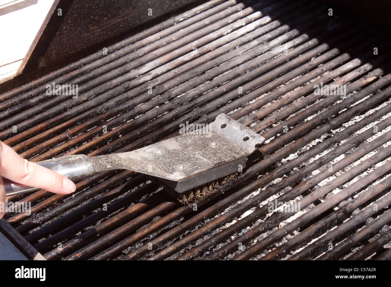 Cleaning a bbq grill Stock Photo Alamy