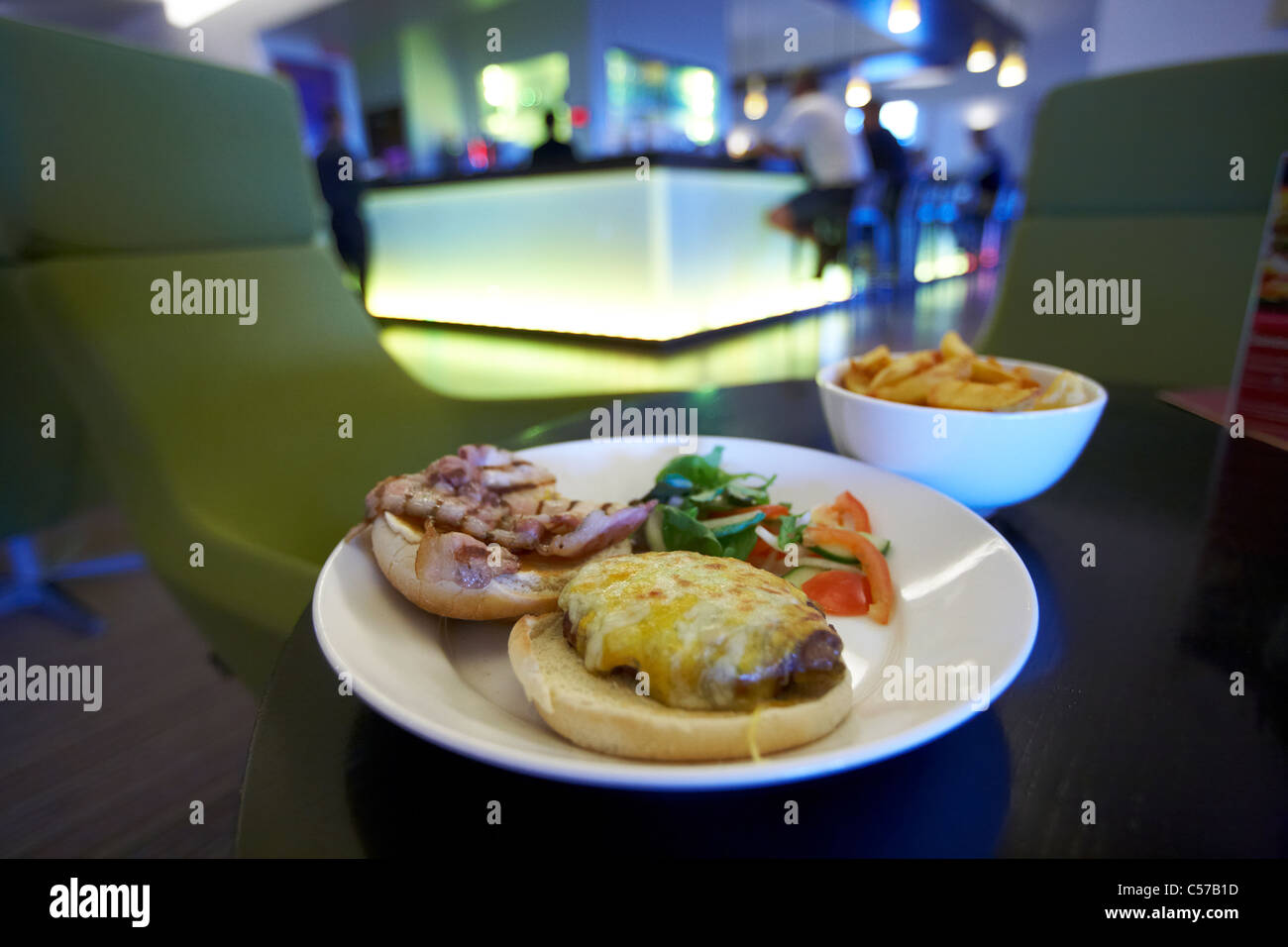 bacon and cheese burger served with salad fries and pint of guinness in a pub bar restaurant in dublin ireland Stock Photo