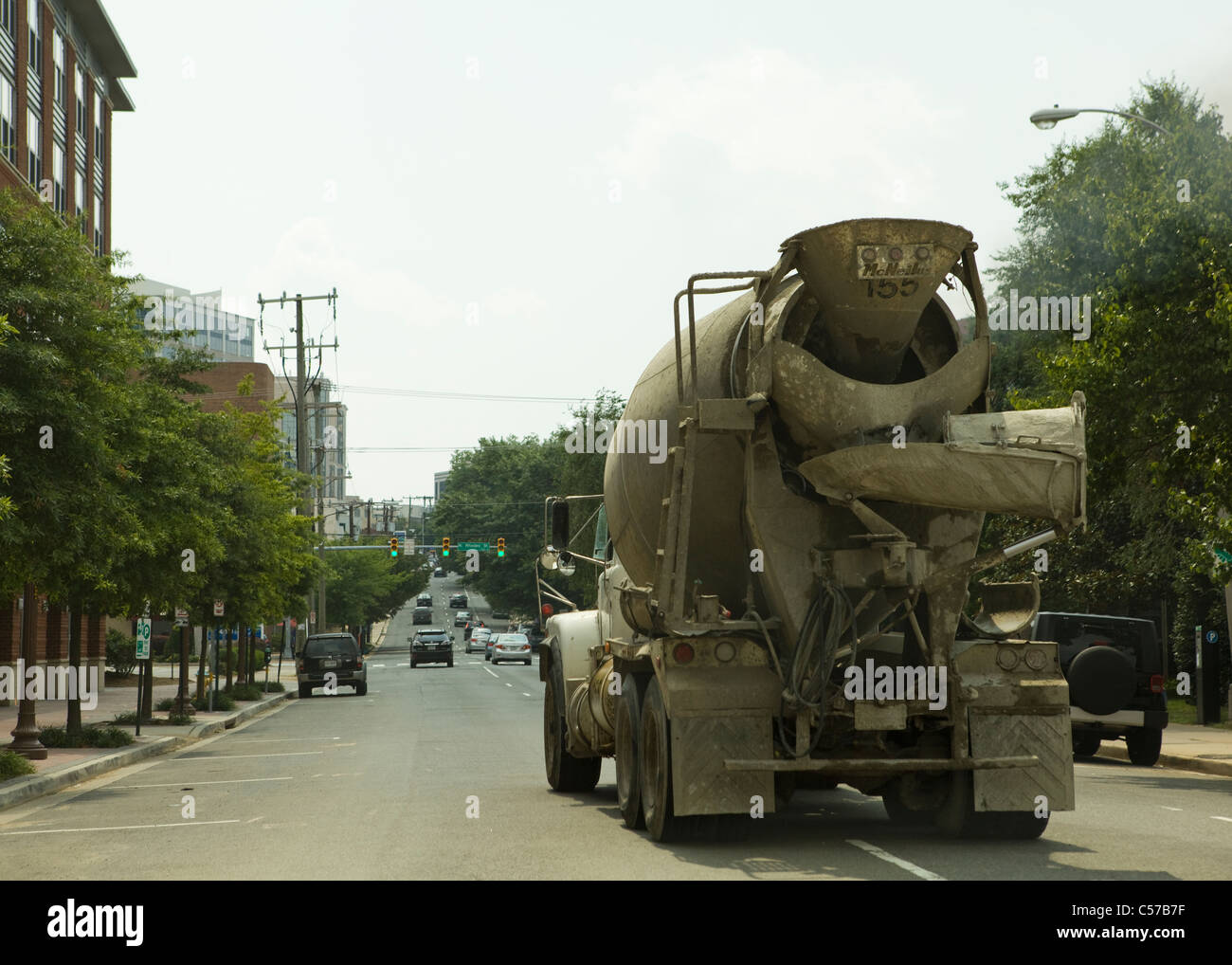 Rear view of a cement mixer truck driving down road USA Stock Photo