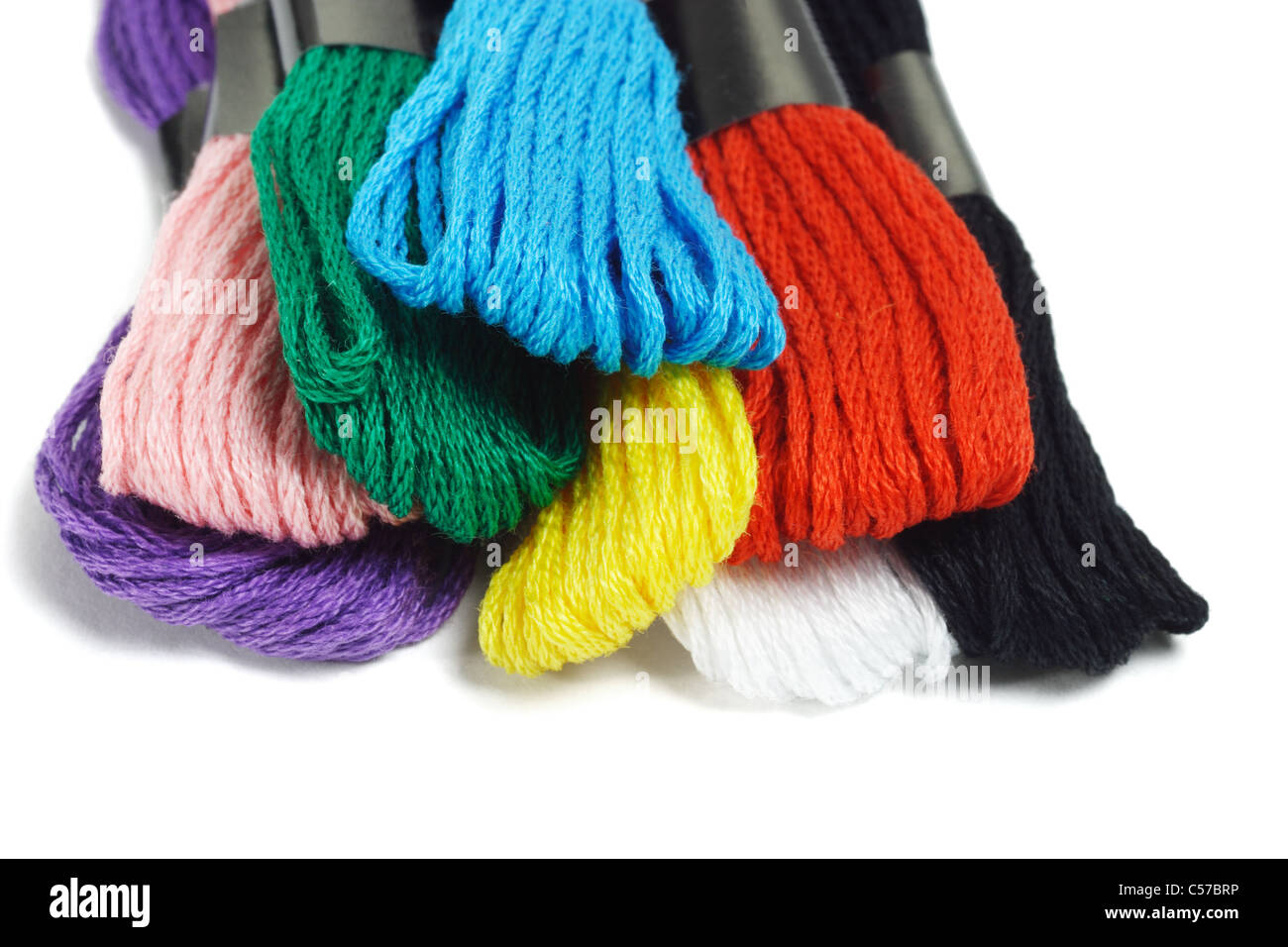 Close up of colorful embroidery threads on white background Stock Photo