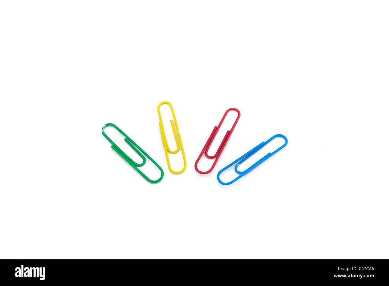 four colored paper clips on white background Stock Photo