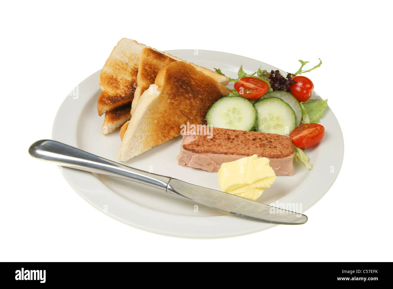 Pate toast and salad with a knife on a white plate Stock Photo