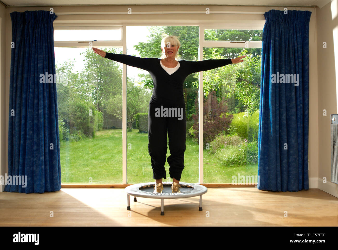 Woman jumping on exercise trampoline Stock Photo Alamy
