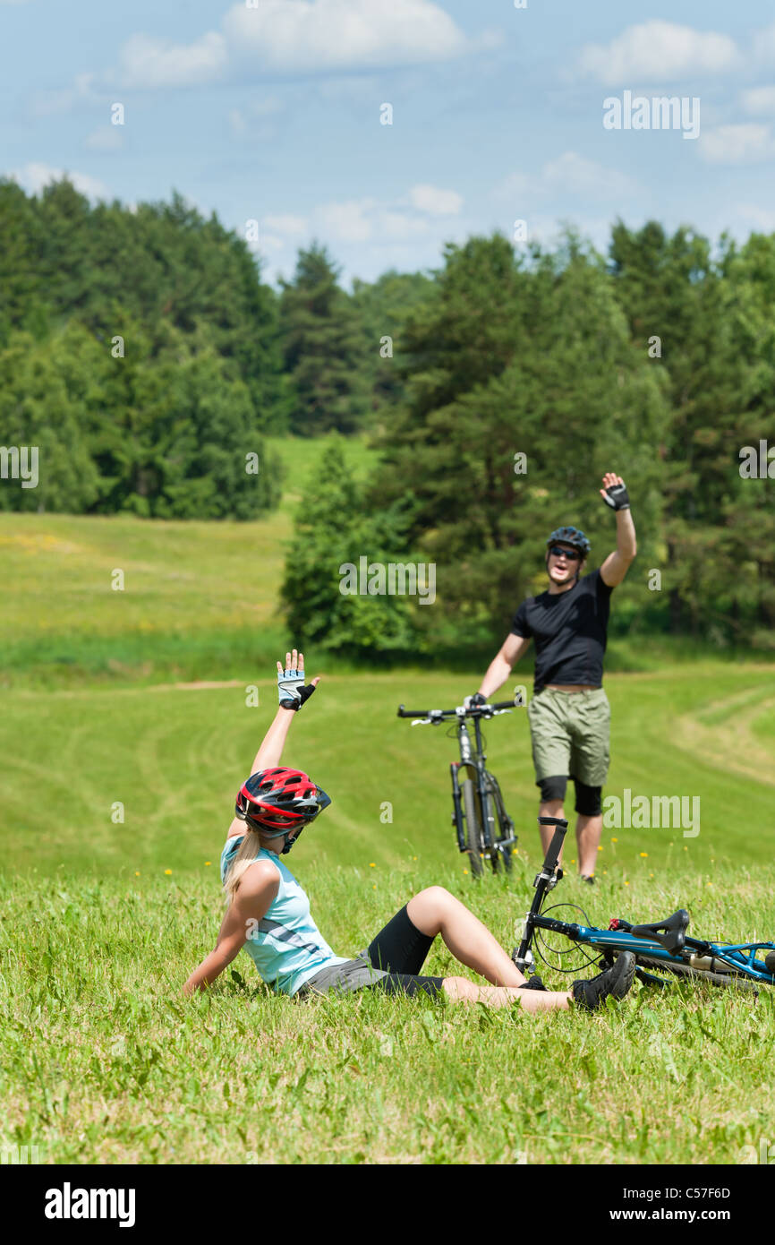 Sport mountain biking happy couple greeting in meadows sunny countryside Stock Photo