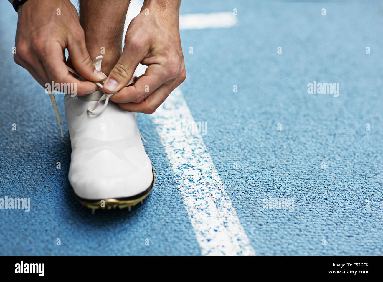 Runner tying shoelaces Stock Photo Alamy