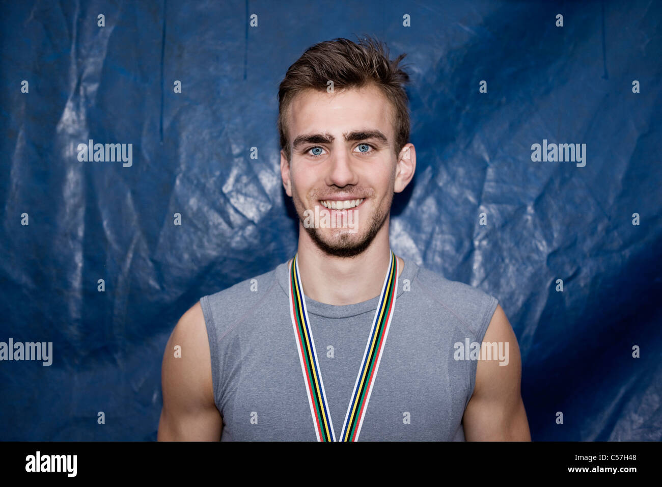 Smiling runner wearing medal Stock Photo