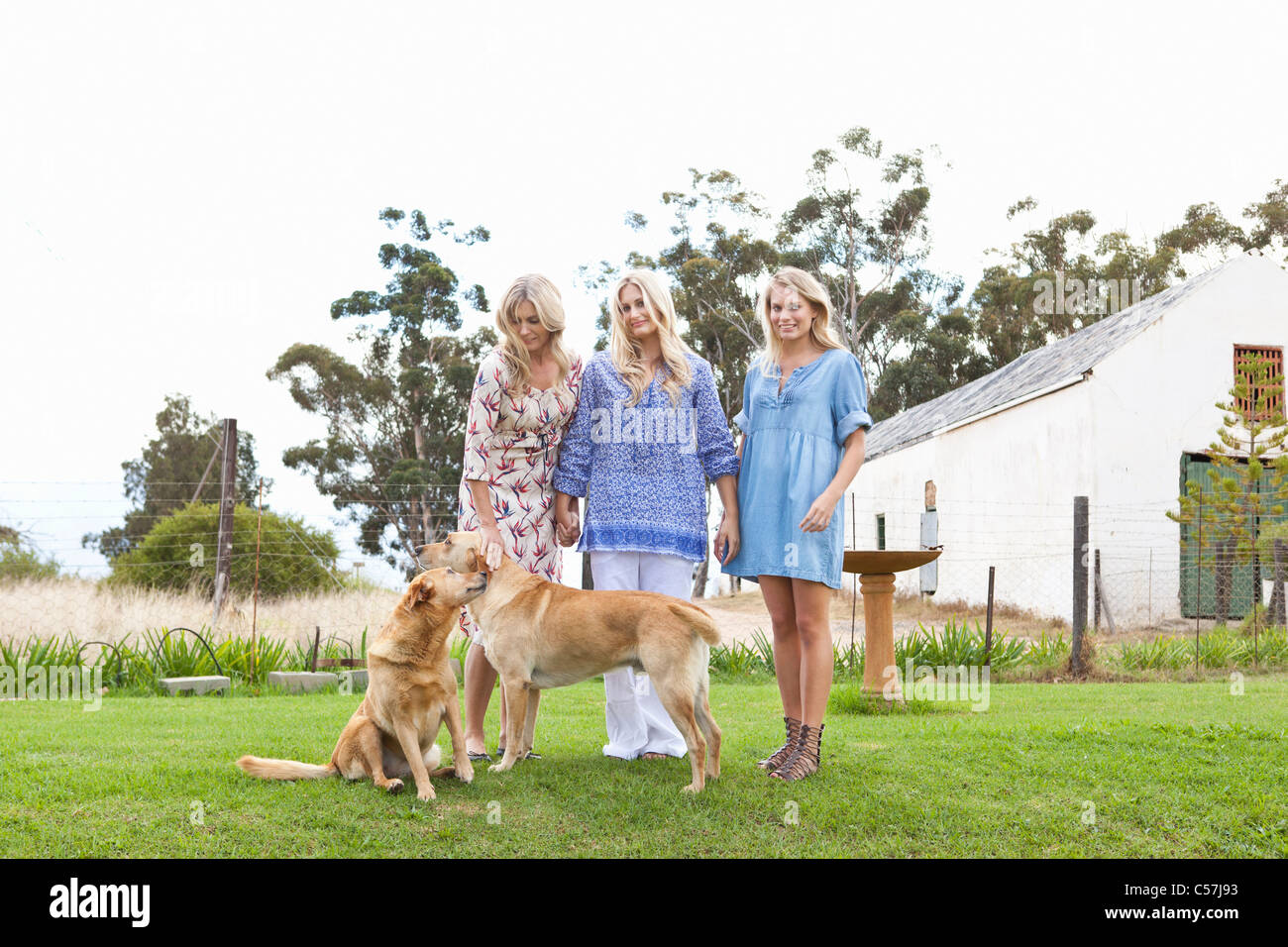 Mother and daughters with dogs in garden Stock Photo Alamy