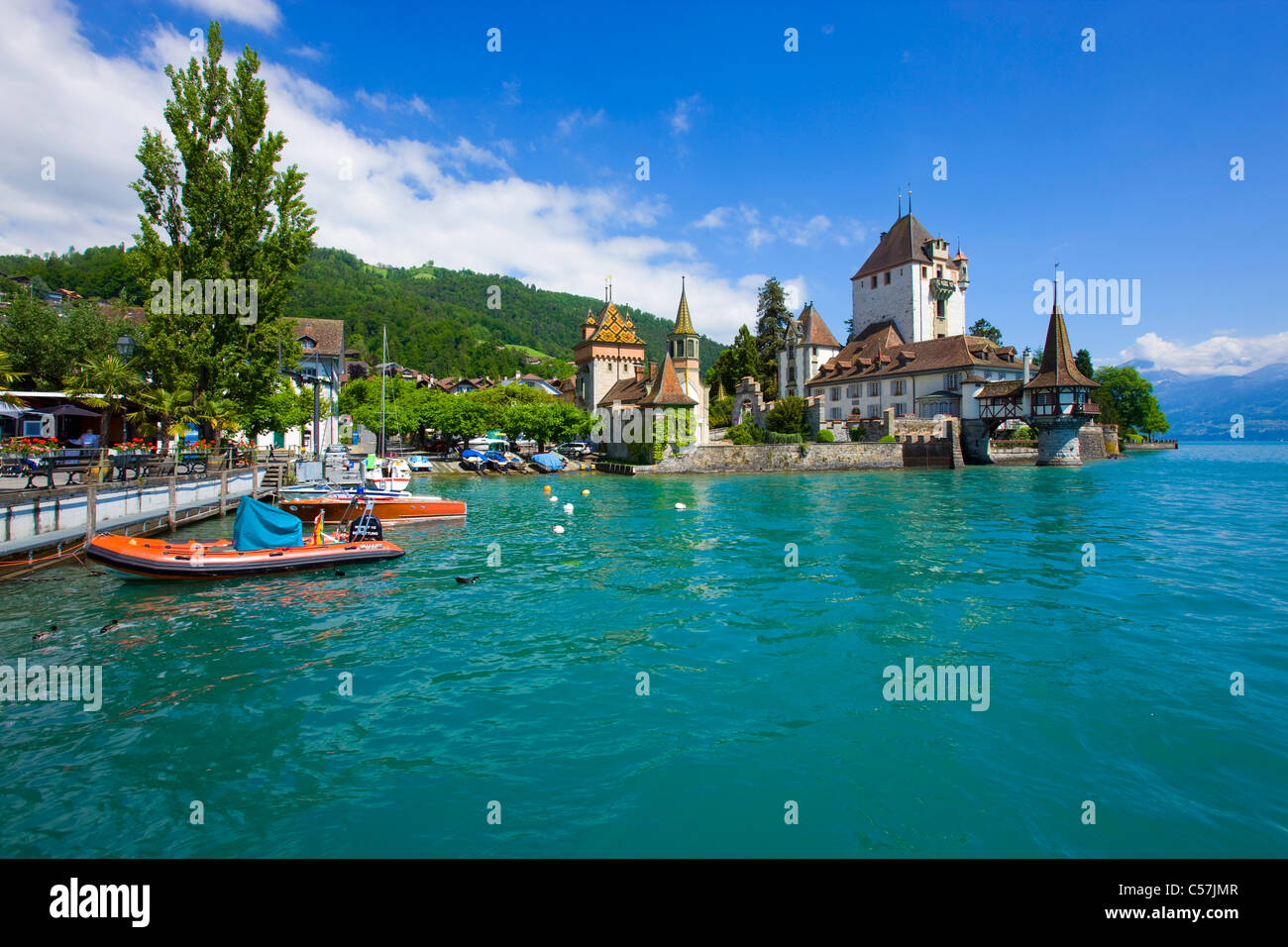 Oberhofen, Switzerland, Europe, canton Bern, lake, sea, lake of Thun, castle, lock, harbour, port, boats, clouds Stock Photo
