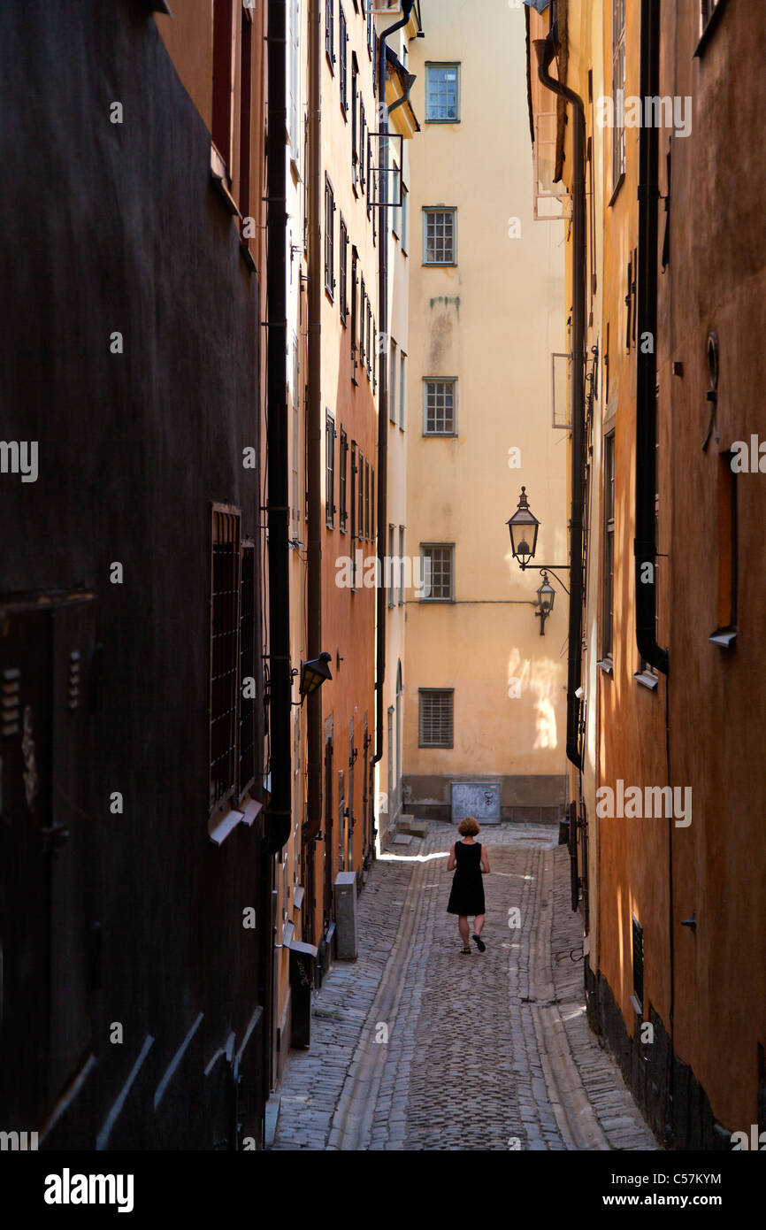 Woman walking narrow old town hi-res stock photography and images - Alamy