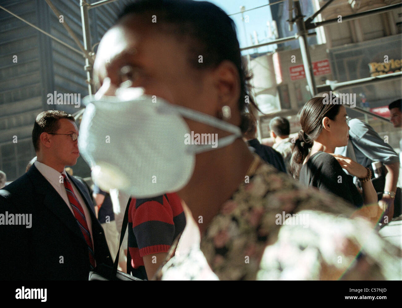 A woman walks down Broadway wearing a mask on September 19, 2001 Stock