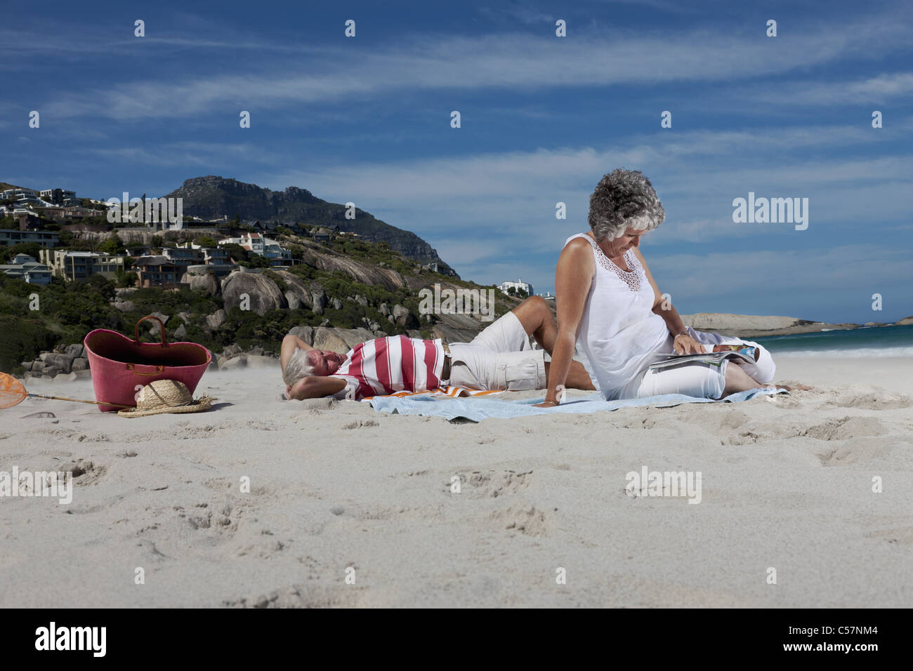 Older couple relaxing together on beach Stock Photo - Alamy