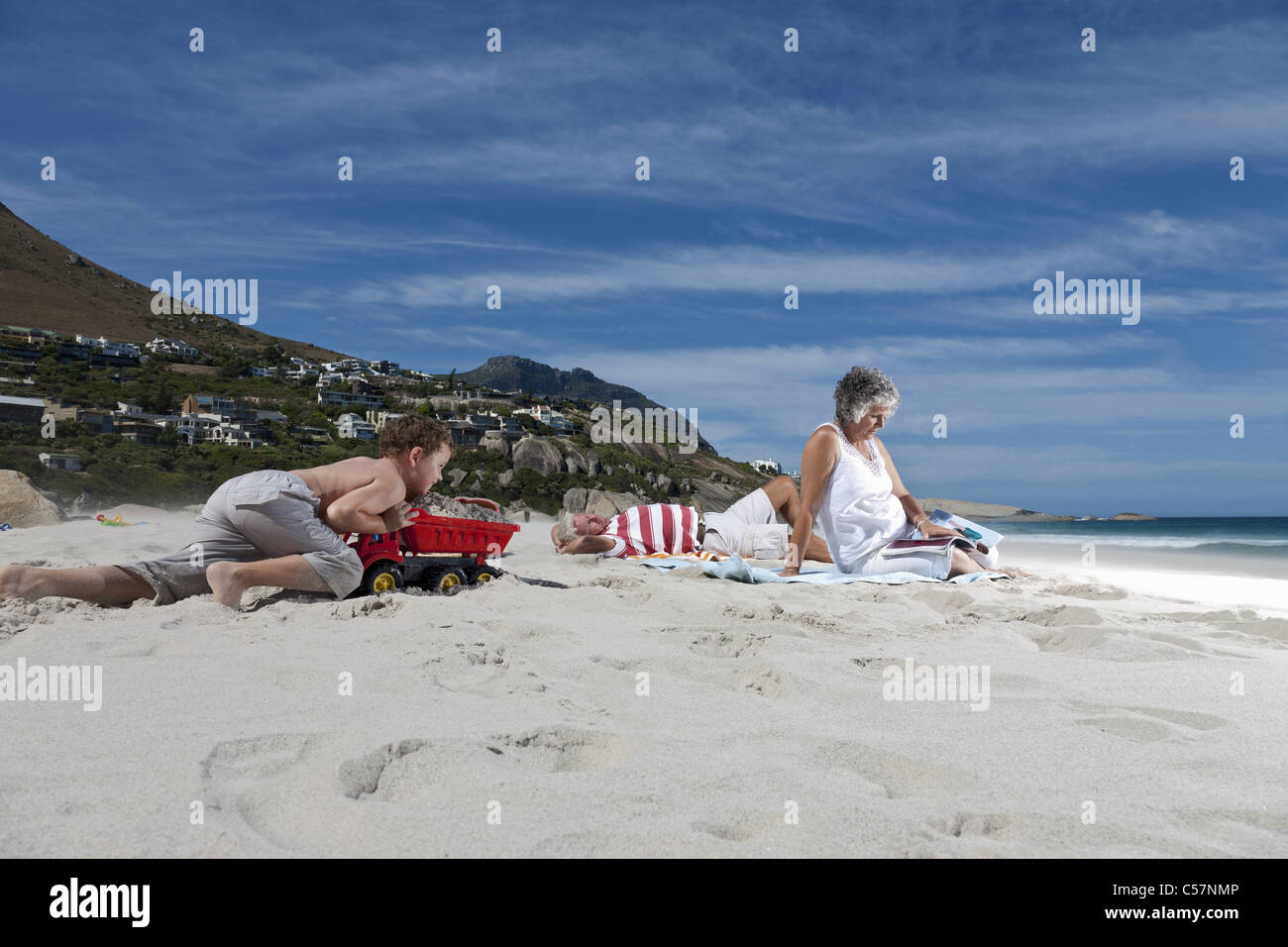 Older couple on beach with grandson Stock Photo