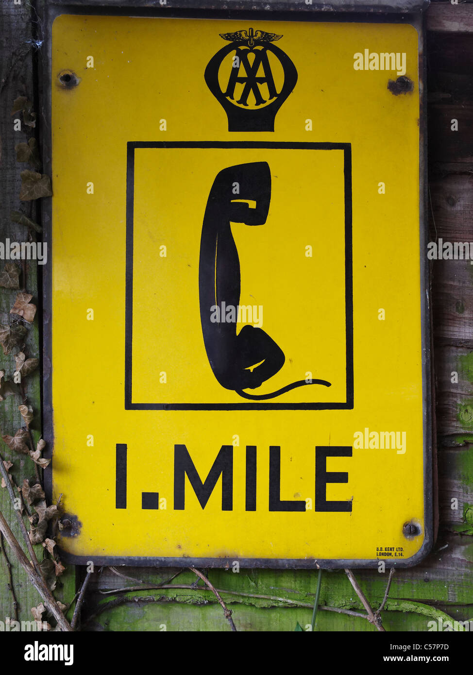 An old metal sign indicating the distance to the nearest AA phone box. Stock Photo