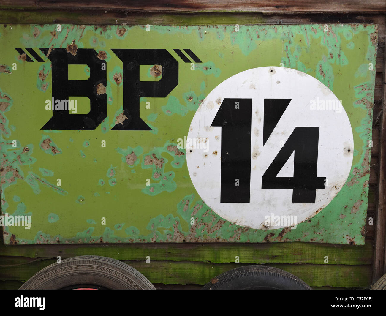 An old enamel sign advertising BP petrol at a pre-decimalisation price. Stock Photo