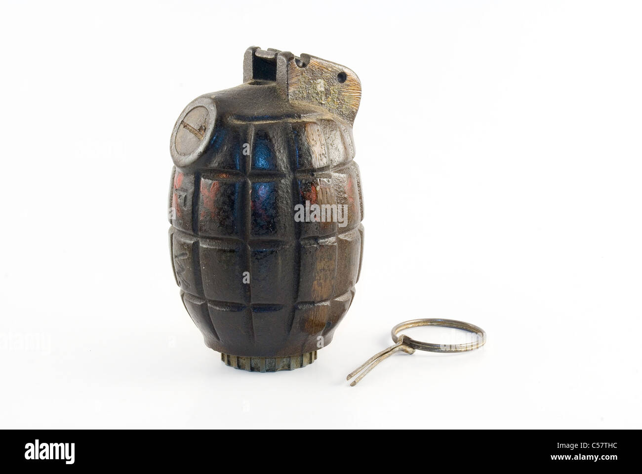 An authentic WWII era hand grenade with pin pulled out isolated on a white background. Stock Photo