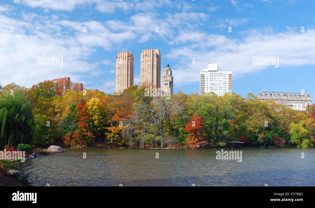 New York City Central Park panorama view in Autumn with Manhattan skyscrapers and colorful trees over lake with reflection. Stock Photo