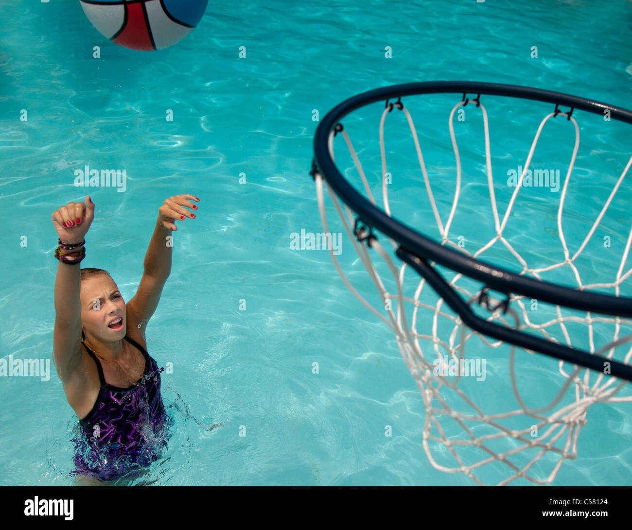 Young girl playing basketball in a swimming pool Stock Photo Alamy