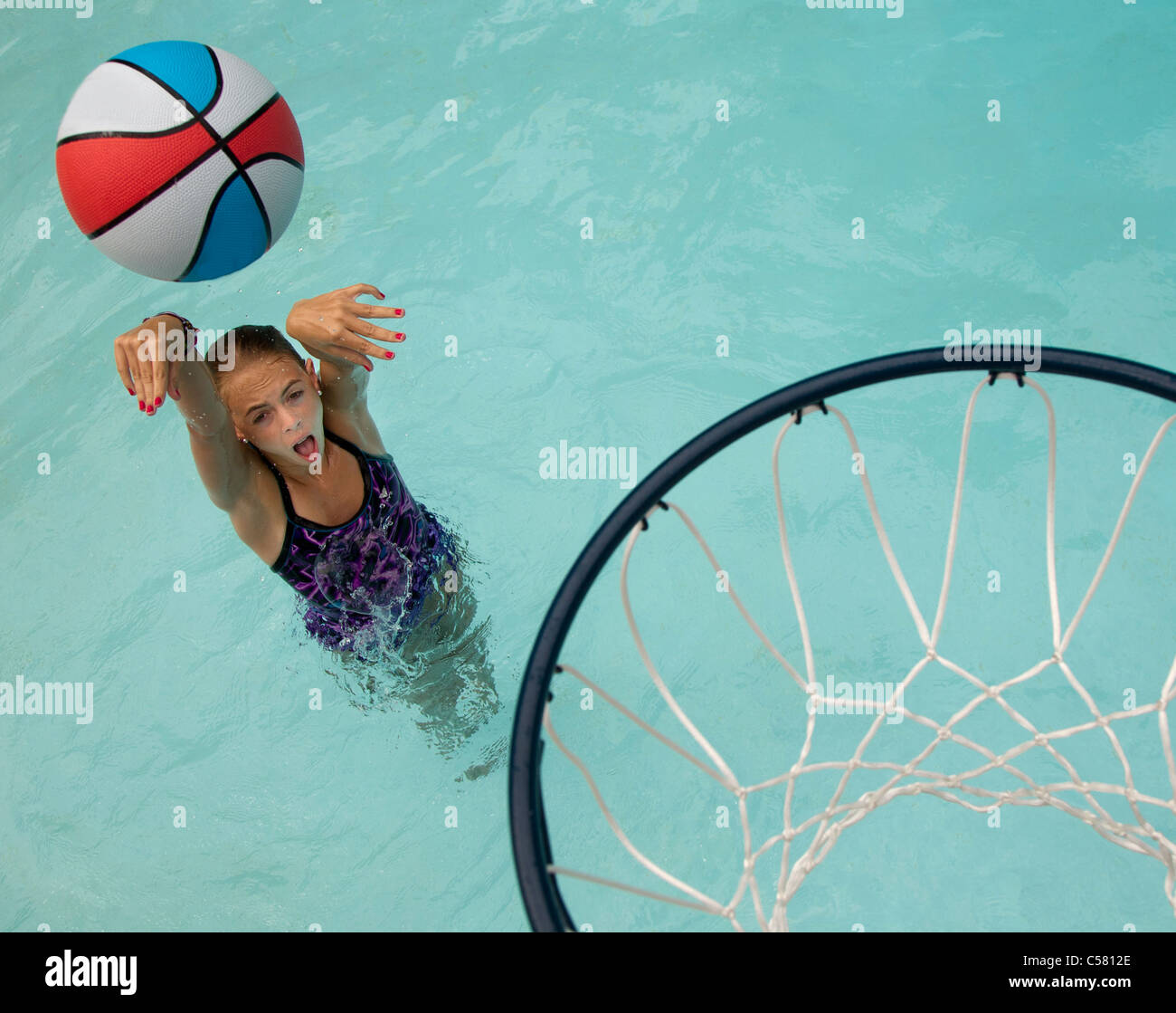 Young girl playing basketball in a swimming pool Stock Photo Alamy