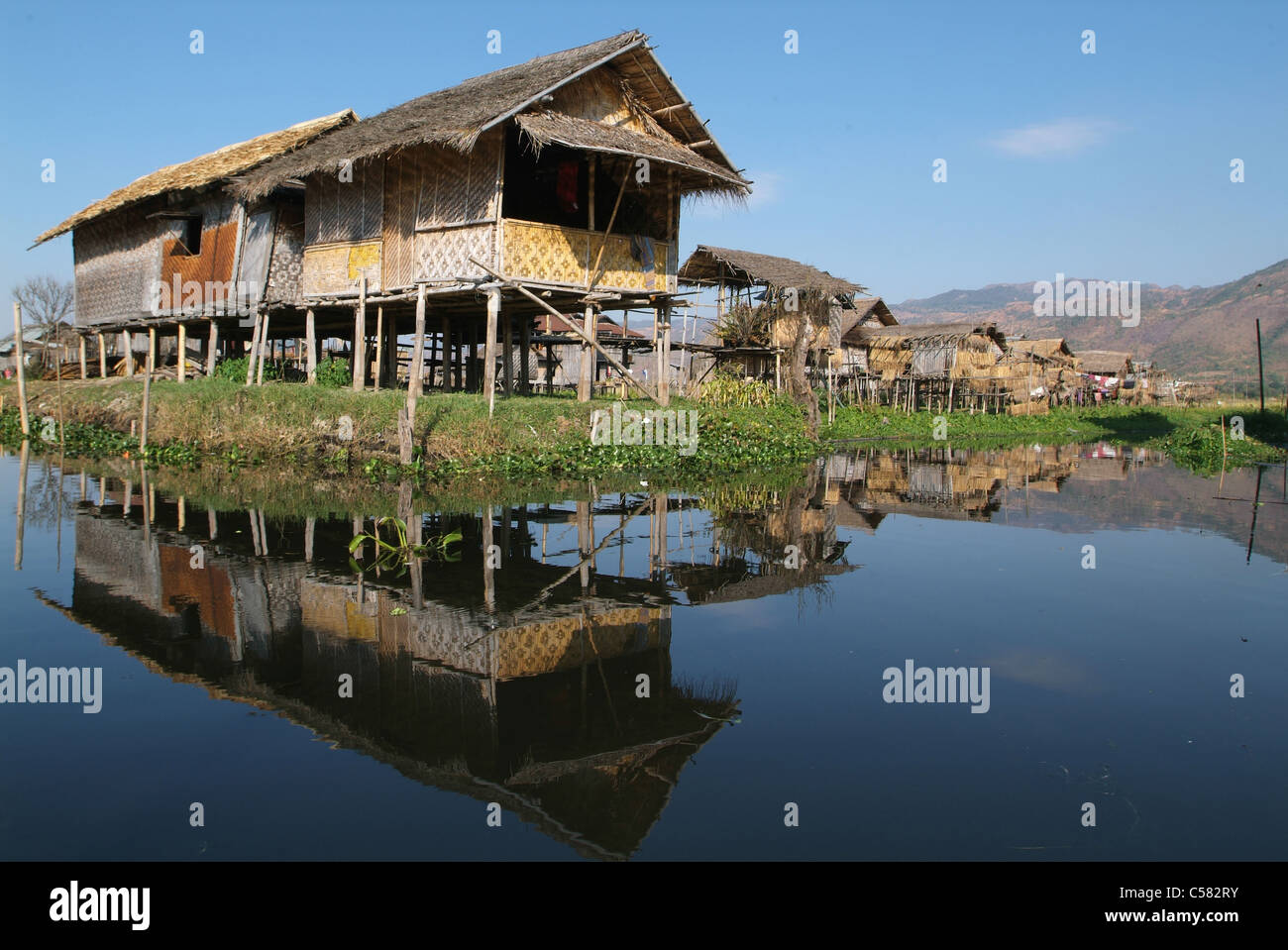 Asia, Burma, Myanmar, lake Inle, Maing Thauk, posts, canoe, hut, water Stock Photo
