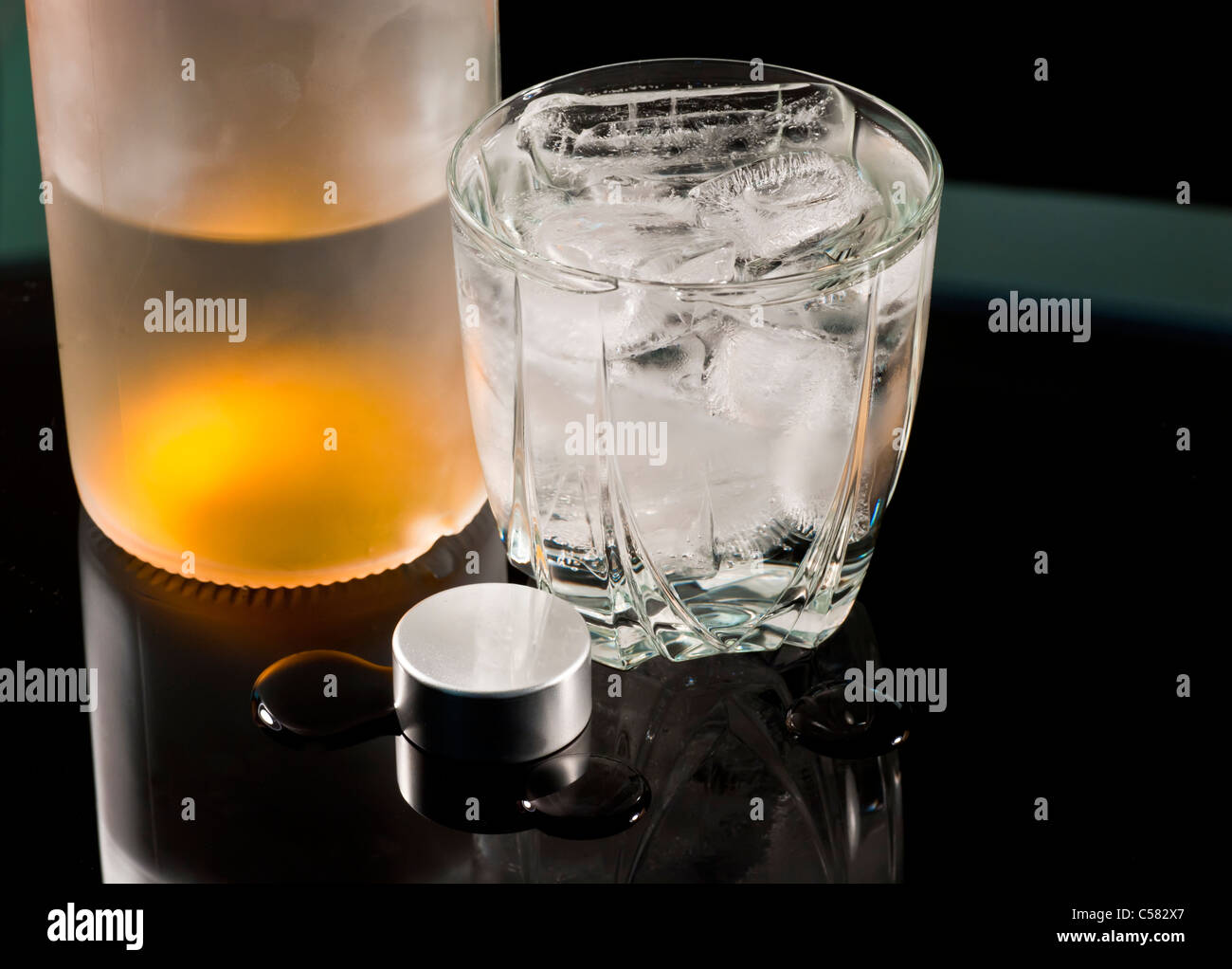 Vodka on the rocks with reflection. Stock Photo