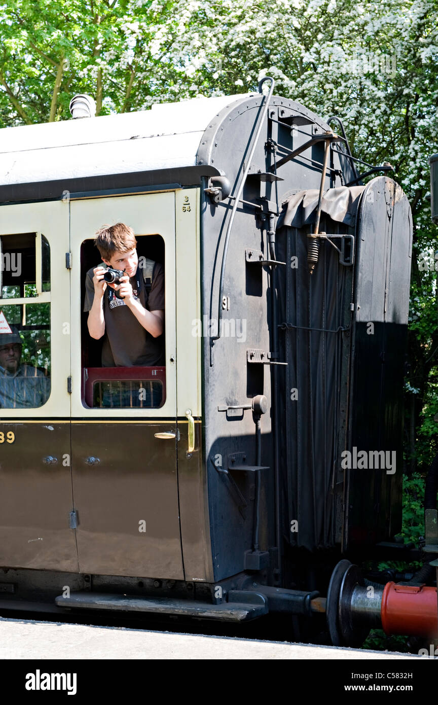 A railway enthusiast with camera on a train at the Didcot Steam Centre, UK Stock Photo
