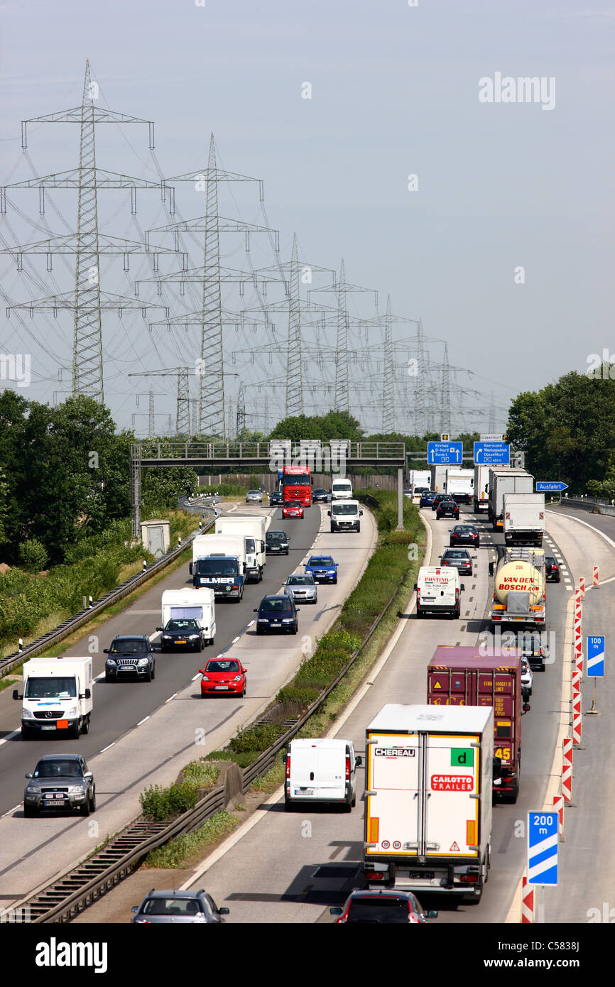 Autobahn A57, traffic, electric power lines, high tension power lines, high voltage power lines. Germany. Stock Photo
