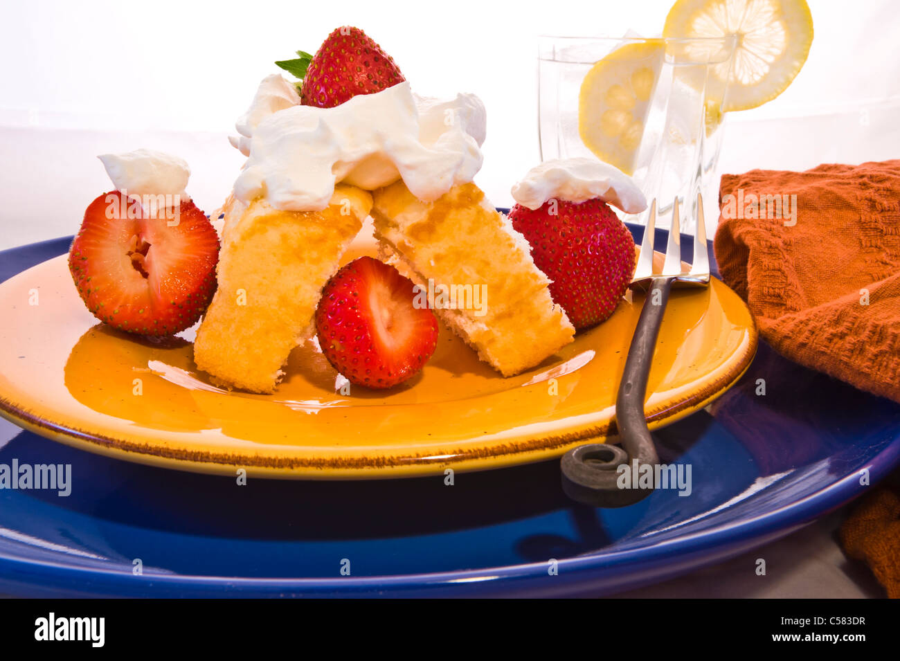 Strawberry shortcake with fresh berries and whipped cream. Ice water ...
