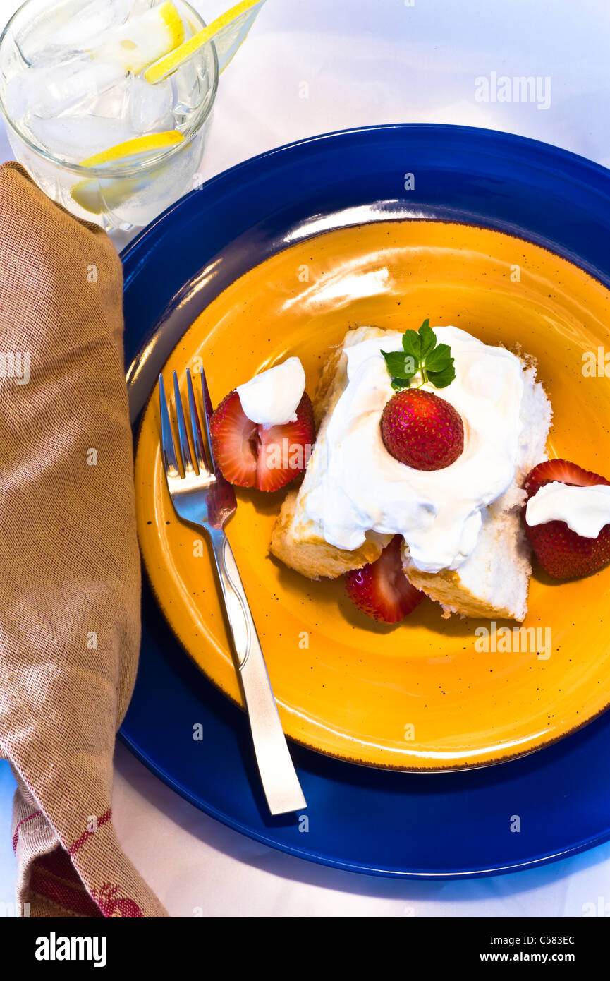 Strawberry shortcake with fresh berries and whipped cream. Ice water ...