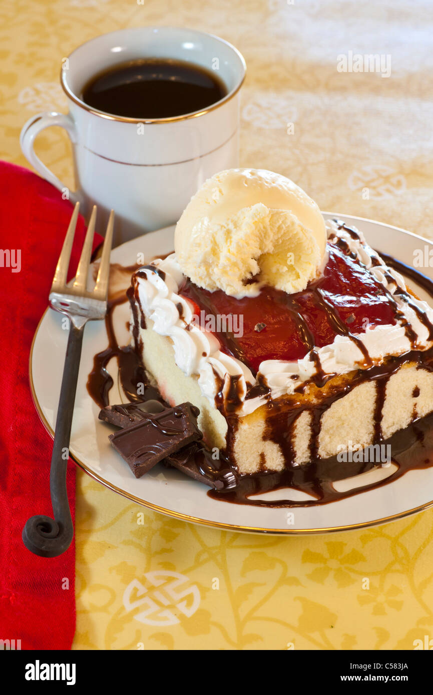 White cake with raspberry chocolate topping and vanilla ice cream. Stock Photo