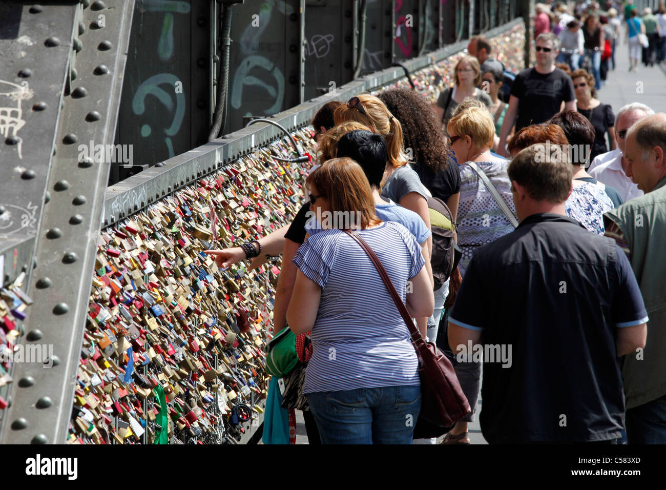 Hohenzollern-bridge over river Rhine in Cologne, Germany. Lovers hang padlocks with their names on it, symbol for eternal love. Stock Photo