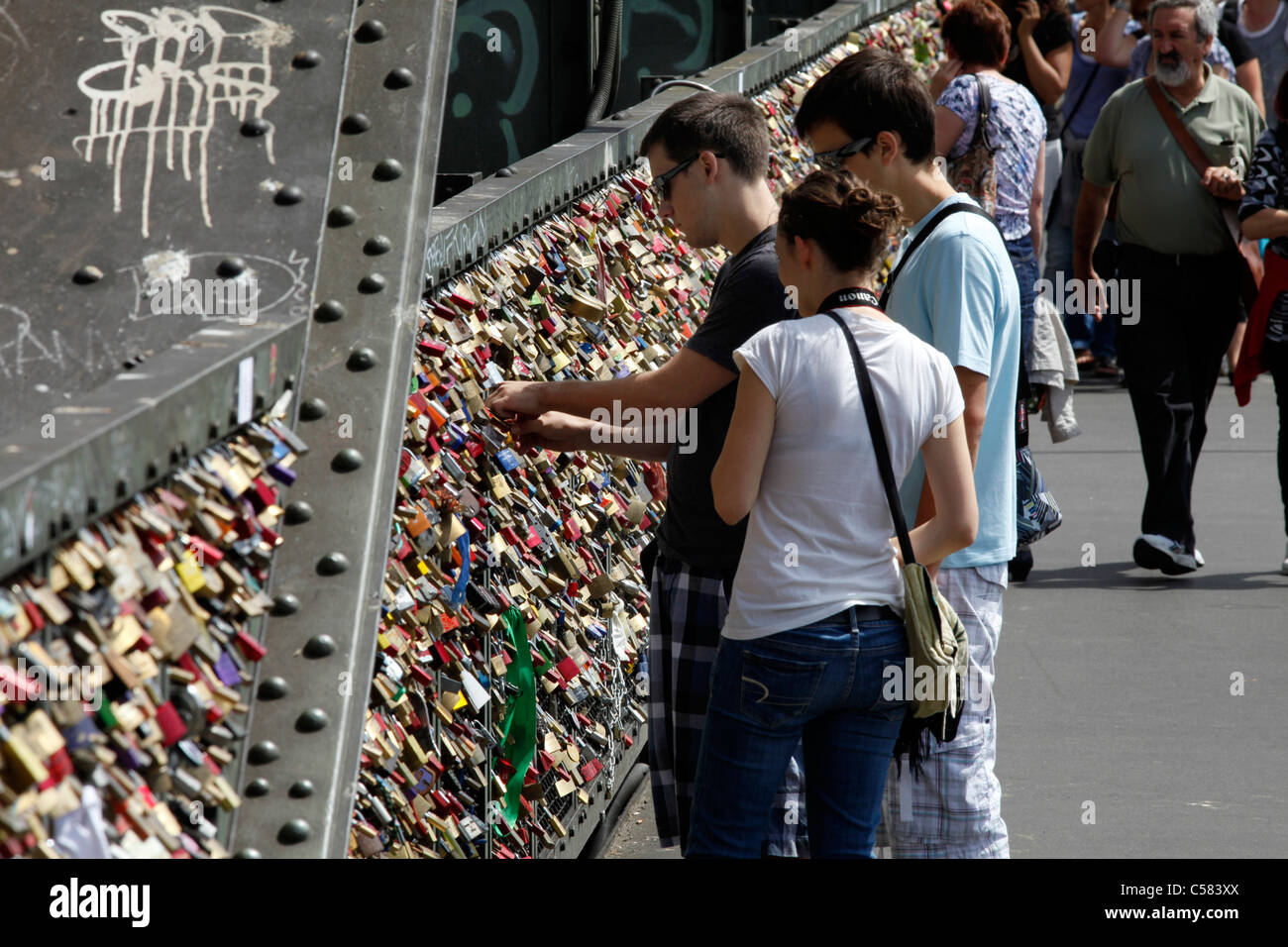Hohenzollern-bridge over river Rhine in Cologne, Germany. Lovers hang padlocks with their names on it, symbol for eternal love. Stock Photo