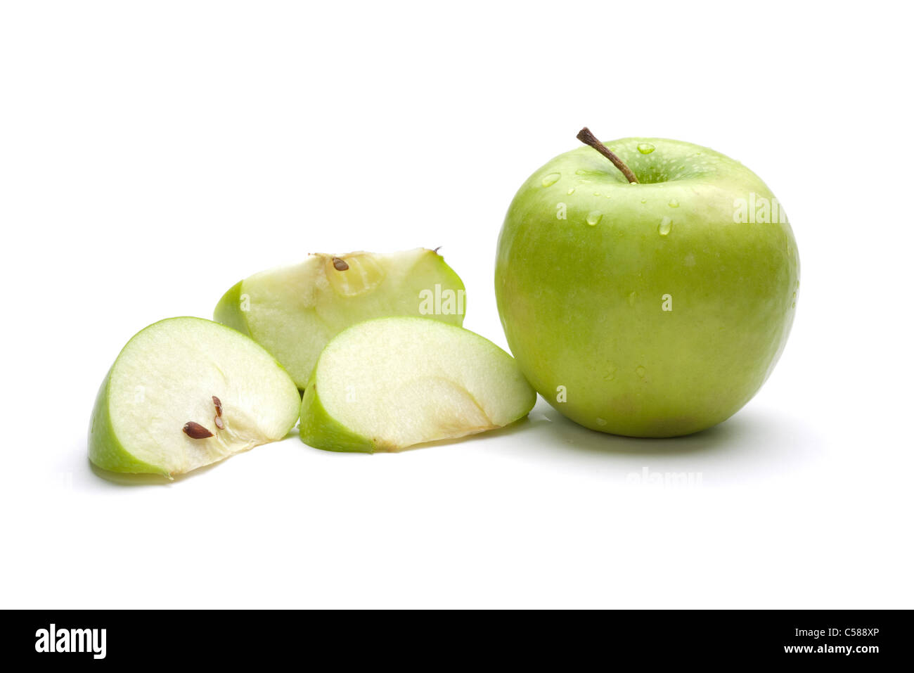 Picture of green uncut apple and apple sliced Stock Photo