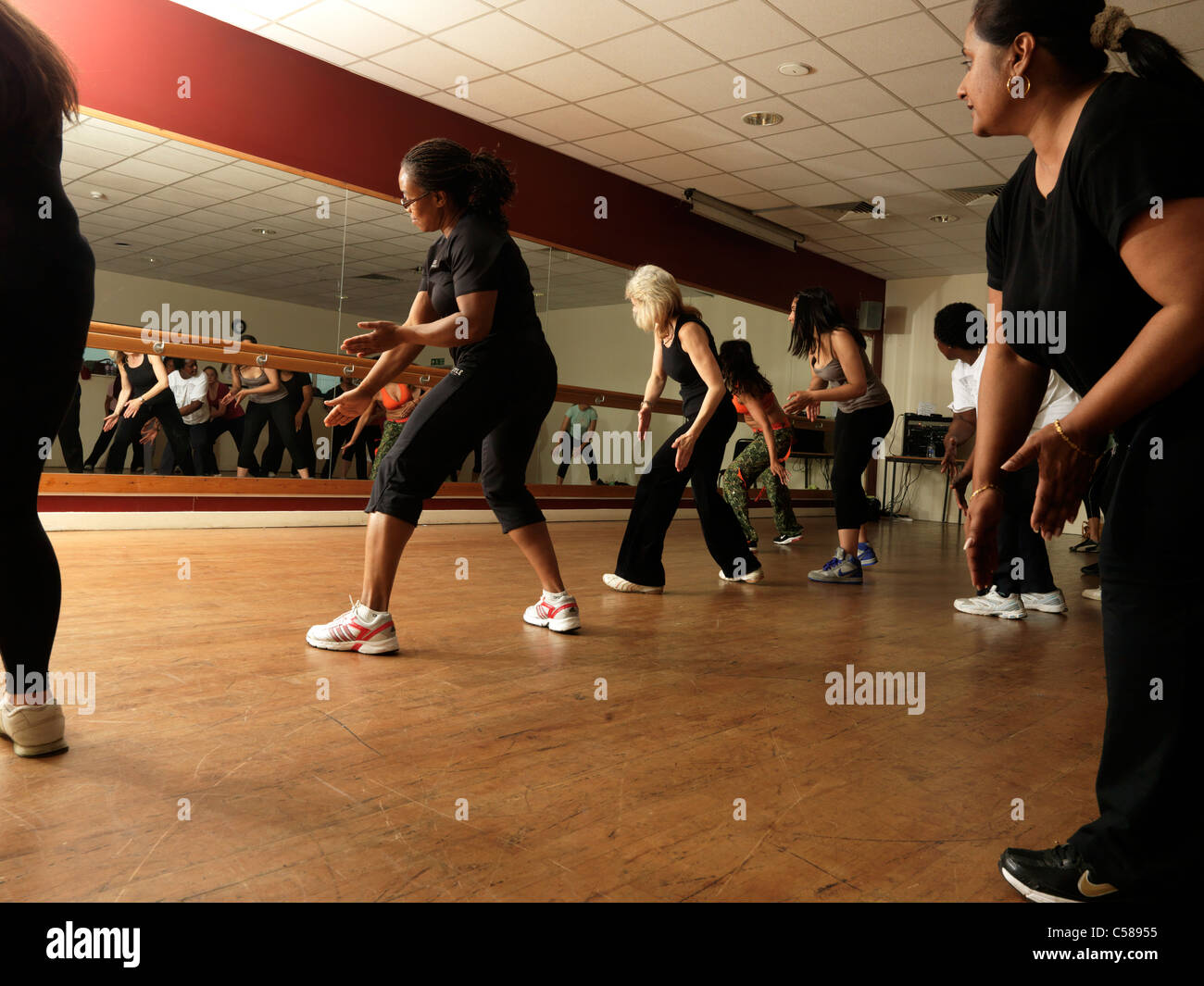 Zumba Dance Fitness Class Women Dancing In Front Of Mirror Stock Photo
