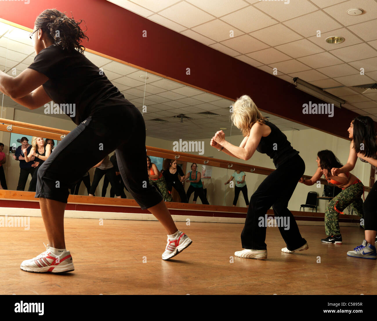 Zumba Dance Fitness Class Women Dancing In Front Of Mirror Stock Photo