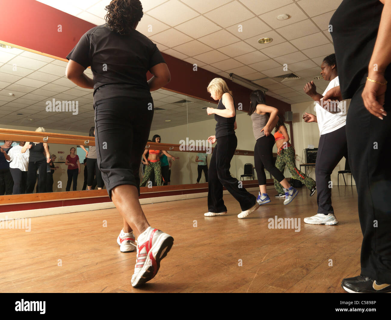 Zumba Dance Fitness Class Women Dancing In Front Of Mirror Stock Photo