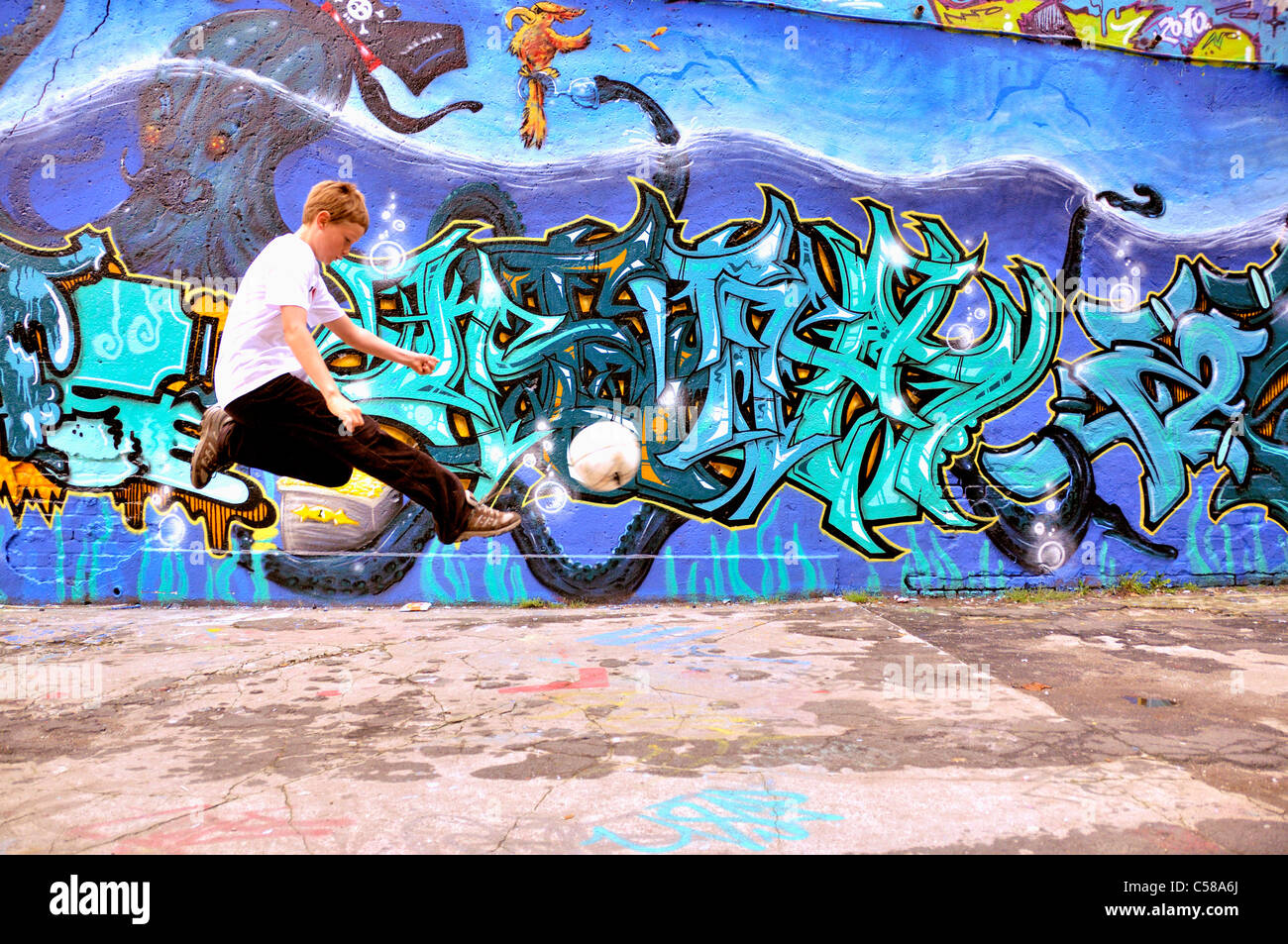 Boy, play, football, soccer, graffiti, spraying, ball, graffiti wall, soccer, football, place, Germany, Europe, art, skill, ball Stock Photo