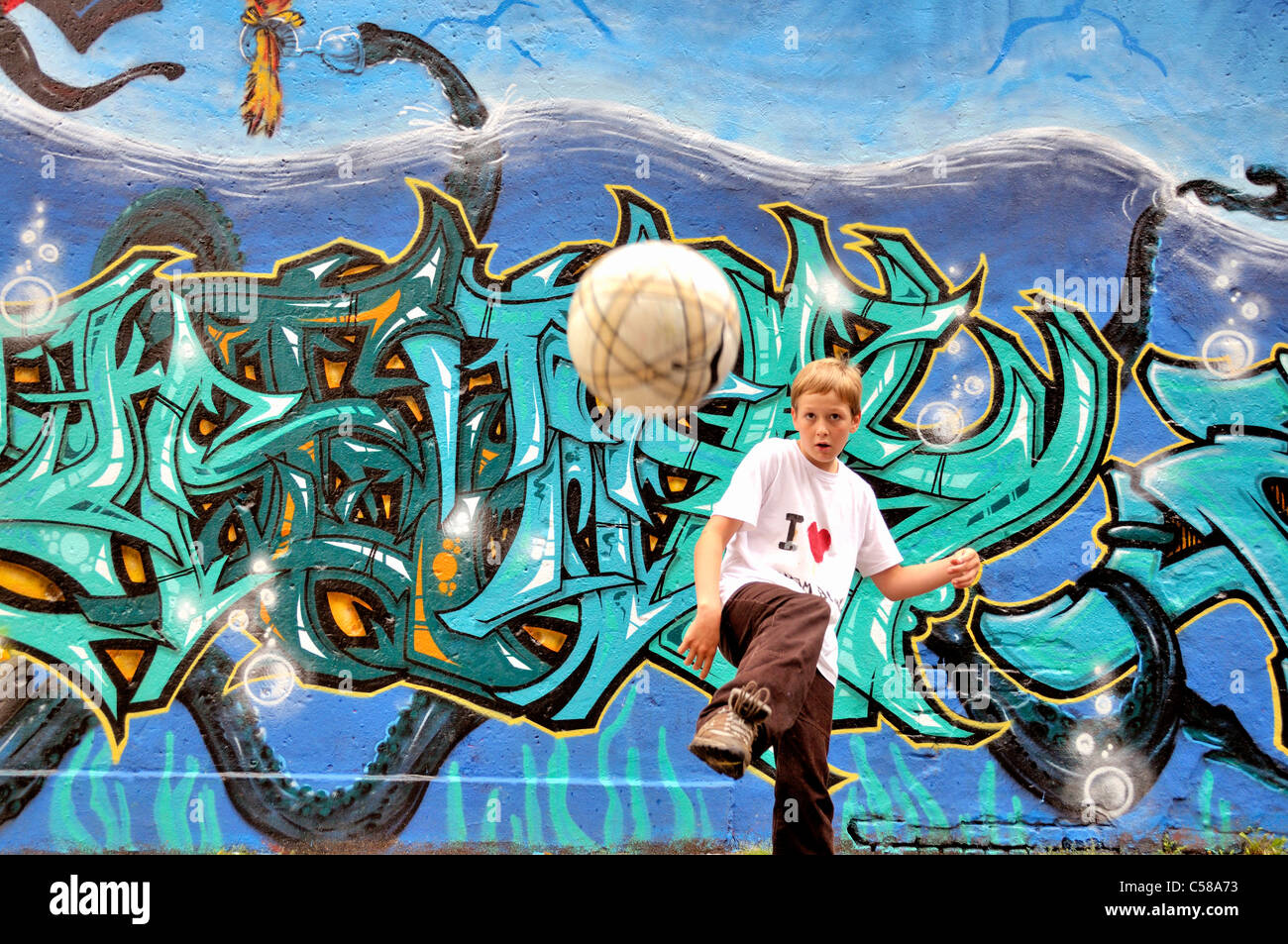 Boy, play, football, soccer, graffiti, spraying, ball, graffiti wall, soccer, football, place, Germany, Europe, art, skill, ball Stock Photo