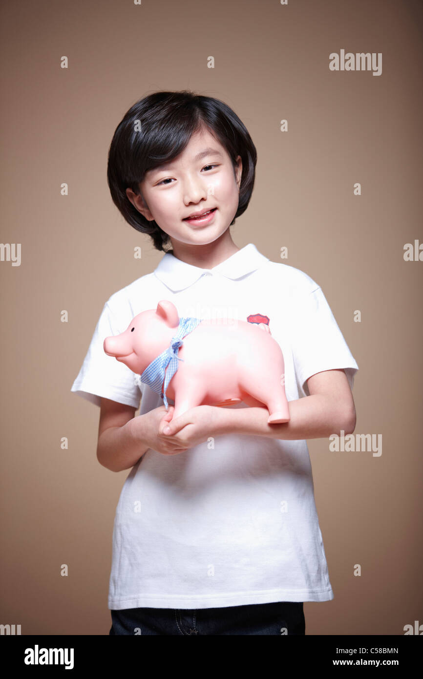 girl holding piggy bank Stock Photo - Alamy