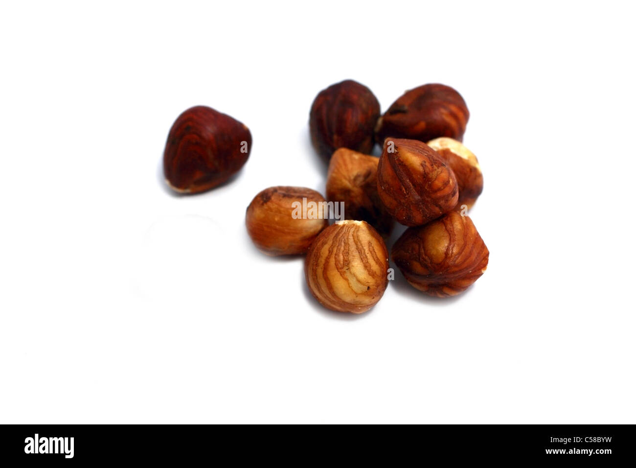 few dry hazelnuts isolated on white background Stock Photo