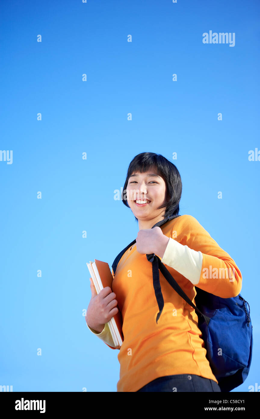 Portrait of teenage girl standing with backpack Stock Photo - Alamy