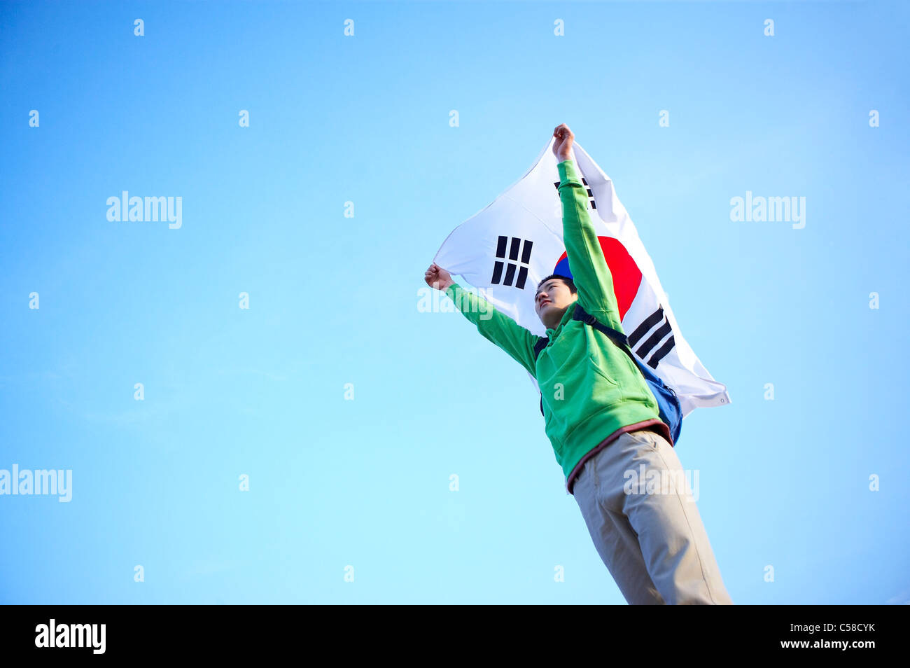 Side view of teenage boy holding flag Stock Photo
