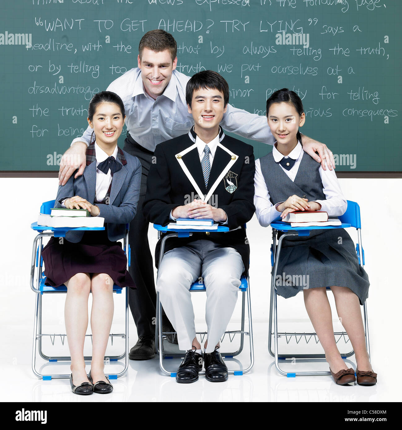 Portrait of teacher and student sitting by blackboard Stock Photo - Alamy
