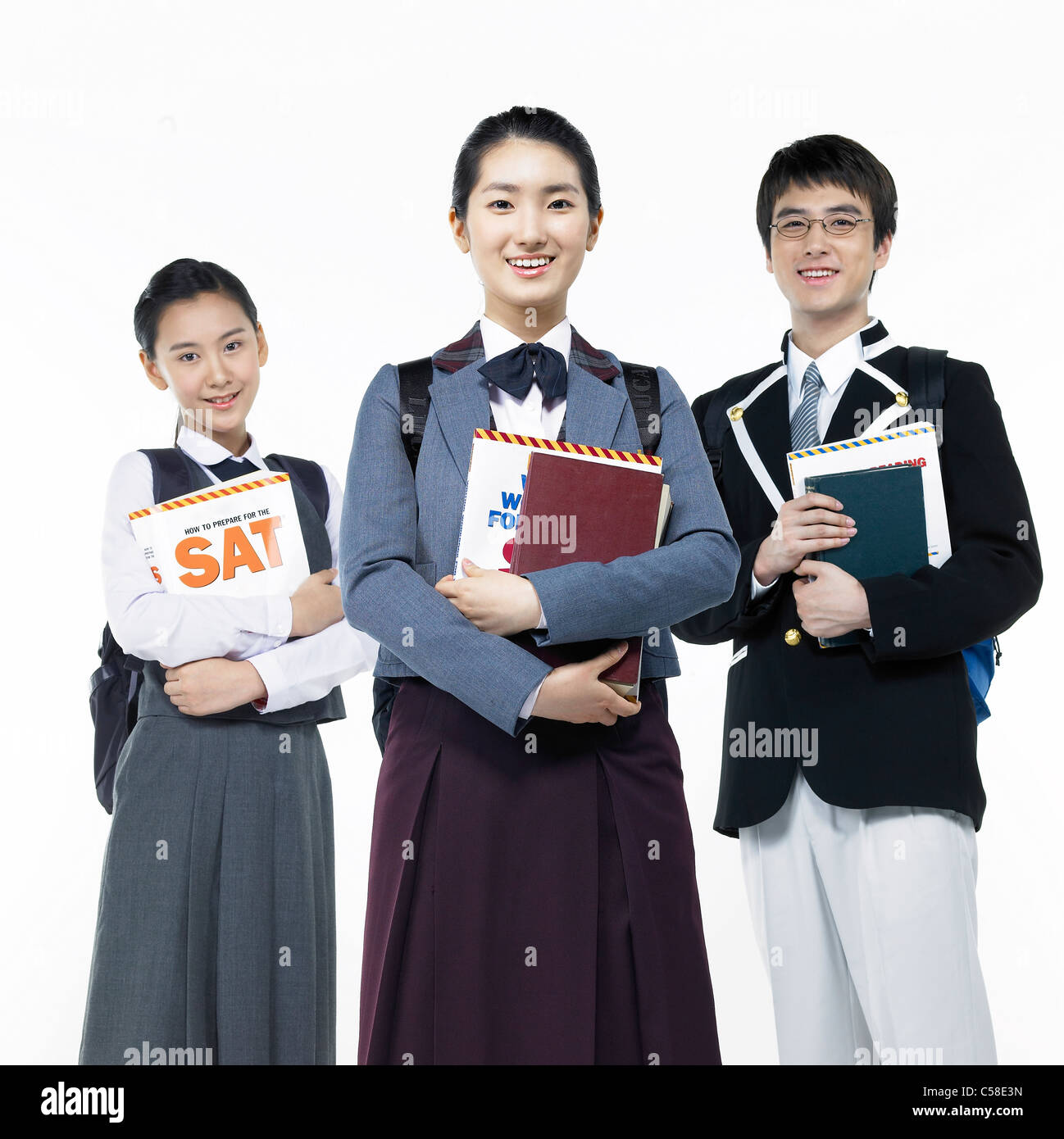 Portrait of teens standing with books Stock Photo - Alamy