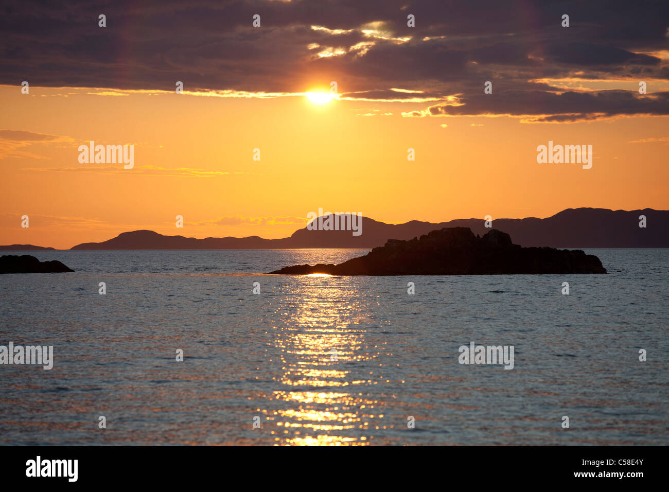 Sunset over the Scottish Isles as seen from Camusdarach in the Western Highlands, Stock Photo